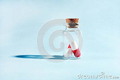 Pills in a glass jar on a light background close-up. medical preparations. vitamins. empty pill jars. chemical production Stock Photo