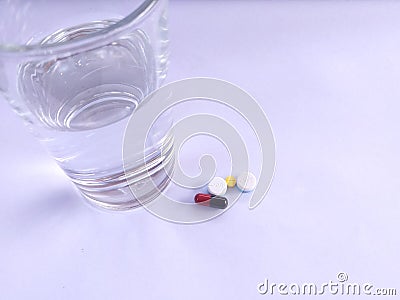 Pills with a glass of water Stock Photo