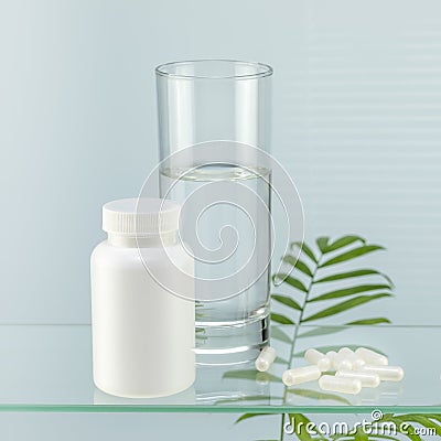 Pills and glass of water on glass shelf with palm leaves Stock Photo