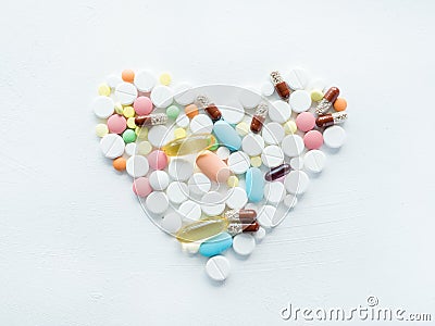 Pill mix heart shape medication illness cure white Stock Photo