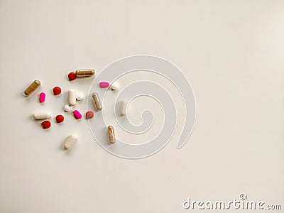 Pills on off-white background, top view with copy space Stock Photo