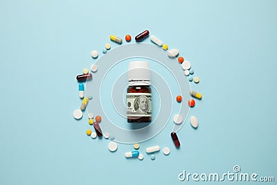Pills and one hundred dollar bill. Dependence on drugs. Pharmaceutical industry, earnings on sick people Stock Photo