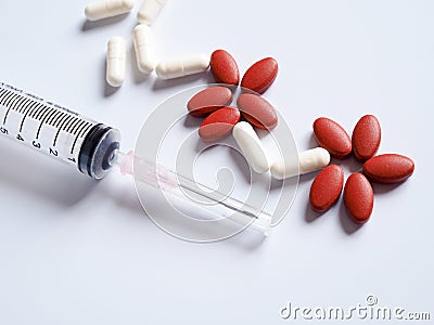 pills, painkiller medication and injection needle with syringe. Stock Photo