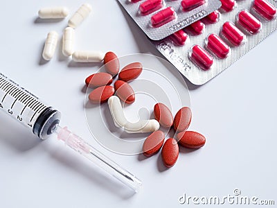 pills, painkiller medication and injection needle with syringe. Stock Photo