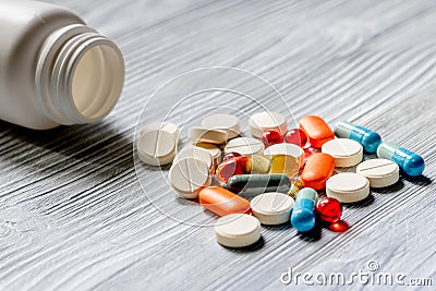 Pills and pill bottle on grey table background Stock Photo