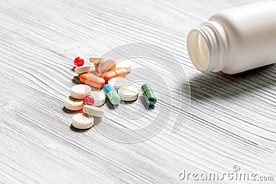 Pills and pill bottle on grey table background copyspace Stock Photo