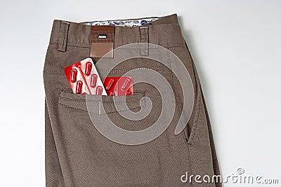 Pills in the pocket of brown jeans, impotence concept, headache Stock Photo