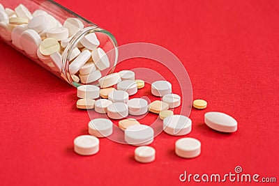 Pills spilling out of pill glass bottle Stock Photo