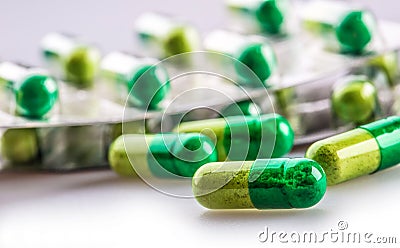 Pills. Tablets. Capsule. Heap of pills. Medical background. Close-up of pile of yellow green tablets Stock Photo