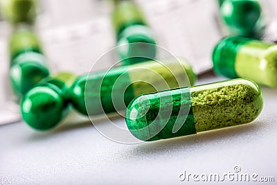 Pills. Tablets. Capsule. Heap of pills. Medical background. Close-up of pile of yellow green tablets Stock Photo