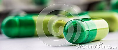 Pills. Tablets. Capsule. Heap of pills. Medical background. Close-up of pile of yellow green tablets Stock Photo