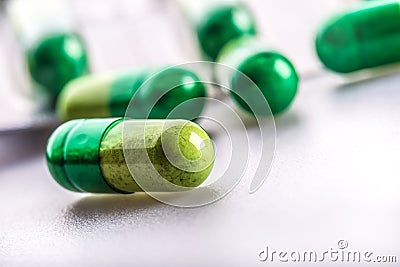 Pills. Tablets. Capsule. Heap of pills. Medical background. Close-up of pile of yellow green tablets Stock Photo