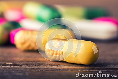 Pills. Tablets. Capsule. Heap of pills. Medical background. Close-up of pile of yellow green tablets - capsule. Pills and tablets Stock Photo