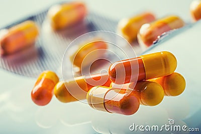 Pills Tablets Capsule or Medicament freely laid on glass background Stock Photo