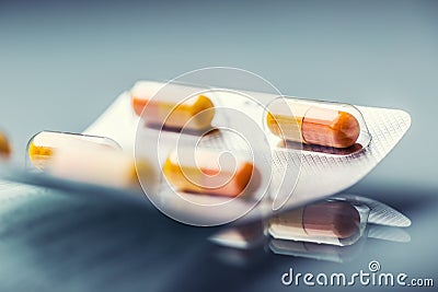 Pills Tablets Capsule or Medicament freely laid on glass background Stock Photo