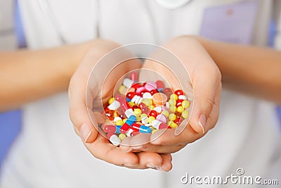 Pills, tablets and drugs heap in doctor's hand Stock Photo