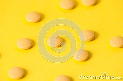 Pills or vitamins on a yellow background with place for text. Pharmacology and medecine concept Stock Photo