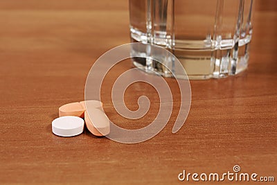 Pills and water glass Stock Photo