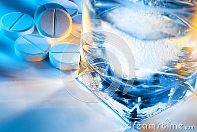 Pills and water glass Stock Photo