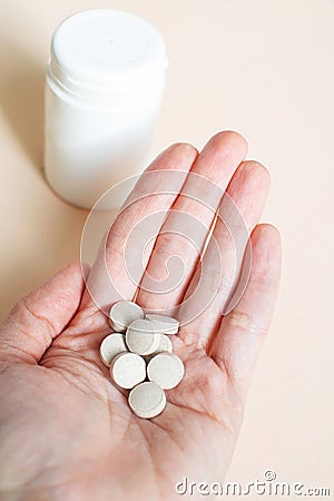 Pills in the woman& x27;s hand. Brewer& x27;s yeast with zinc. Stock Photo