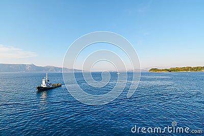 A pilot boat approaches a cruise ship at sea as it nears the island of Corfu Greece, in the Ionian Sea Stock Photo