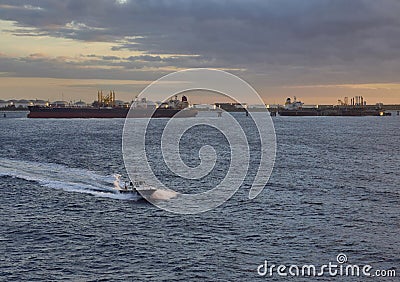 The Pilot Boat passing the Offshore Jetties and coming out to a Vessel at the Anchorage in Freeport, Grand Bahama. Stock Photo