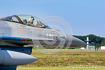 Pilot in the cockpit of a F-16 fighter jet plane taxiing towards the runway at Kleine-Brogel Airbase. Belgium - Sep 8, 2023 Editorial Stock Photo