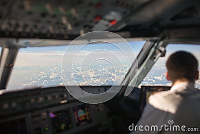 Pilot in a commercial airliner airplane flight cockpit Stock Photo