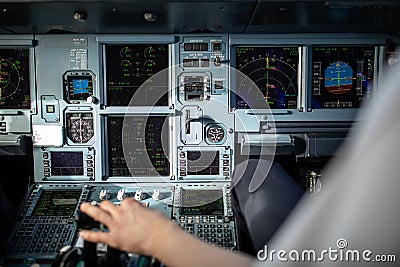 Pilot`s hand accelerating on the throttle in airplane flight cockpit during takeoff Stock Photo