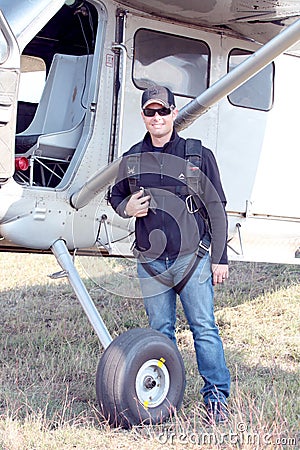 Pilot standing next to his X328 Atlas Angel Turbine specially equipped aircraft for sky divers Editorial Stock Photo