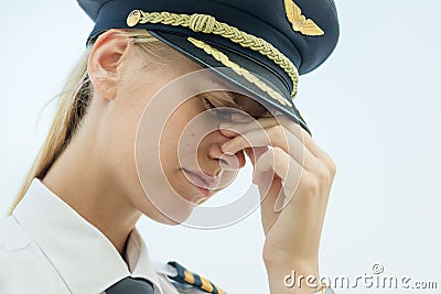 Stressed tired pilot at work in the airport, exhausted from flying Stock Photo