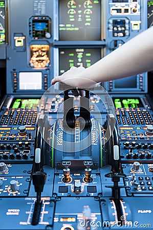 Piloting in an Airplane Cockpit with thrust levers with hand on top for takeoff Stock Photo