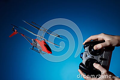 Piloting remote control helicopter Stock Photo