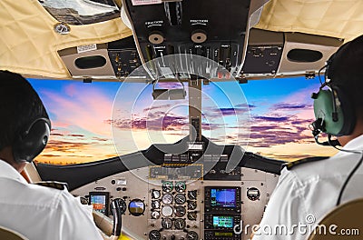 Pilots in the plane cockpit and sunset Stock Photo