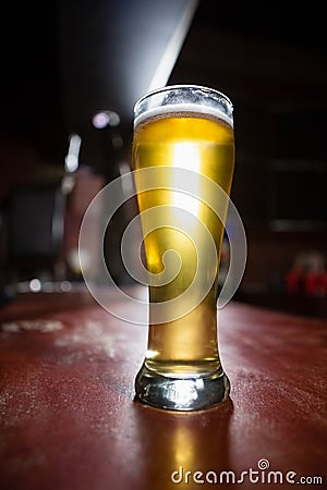 Pilsner beer glass on a table Stock Photo