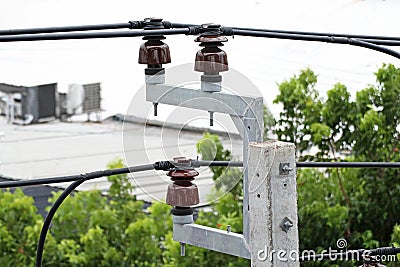 Pin Type High Voltage Insulators and Cable Installation on Concrete Electrical Pole Stock Photo