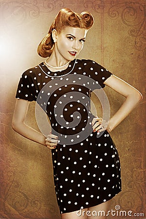 Pin-Up retro girl in classic fashion polka dots dress posing Stock Photo