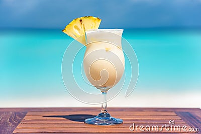 Pina colada coktail on wooden table at the beach Stock Photo