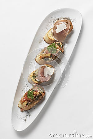 Pinchos tapas with jamon serrano and bruschetta on white background Stock Photo