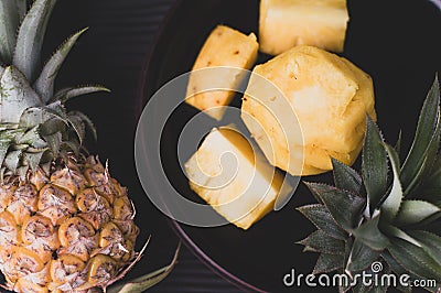 Pine apple on black place and wood background Stock Photo