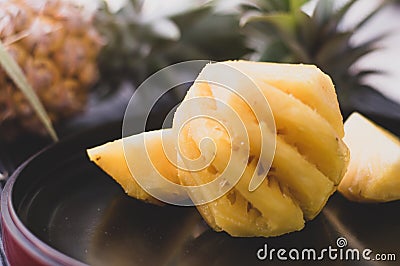 Pine apple pulear on black place and wood background Stock Photo