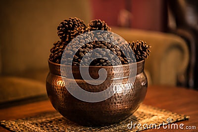 Pine Cones in a Hammered Bronze container Stock Photo
