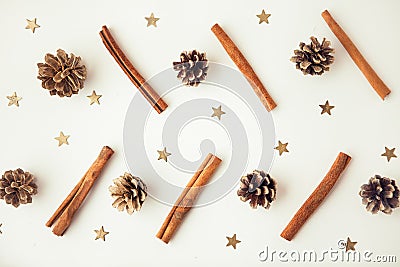 Pine corns, gold stars and cinnamon sticks on the white background Stock Photo