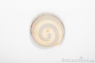 Pine tree cross-section with annual rings on white background. Lumber piece close-up, top view, isolated. Stock Photo