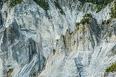 Pine Trees Growing on Dramatic and Rugged Rocky Mountains Cliffs Stock Photo