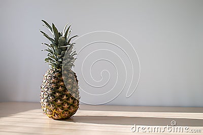 Pineaple on the table in the sun close-up Stock Photo