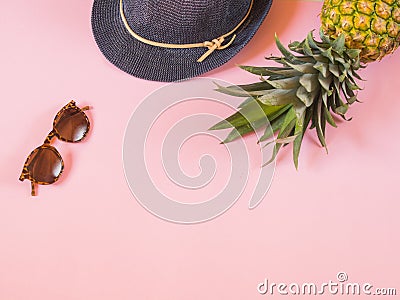 Pineapple, blue hat and sunglasses on pink background with copy Stock Photo