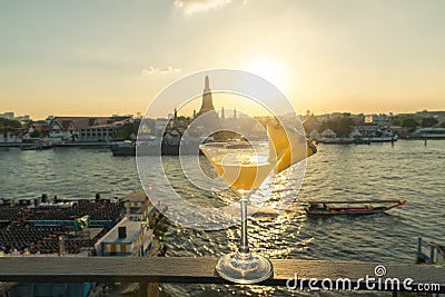 Pineapple cocktail on table in rooftop bar with famous place Stock Photo