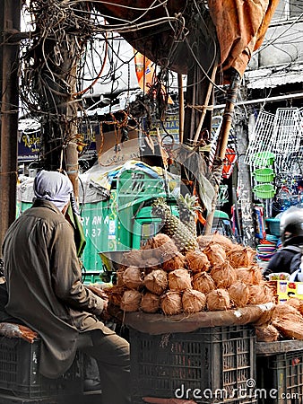 Pineapple and coconut seller in Chandni Chowk, Old Delhi. Editorial Stock Photo