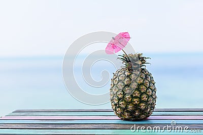 Pineapple fruit on vintage wood floor with seascape background Stock Photo